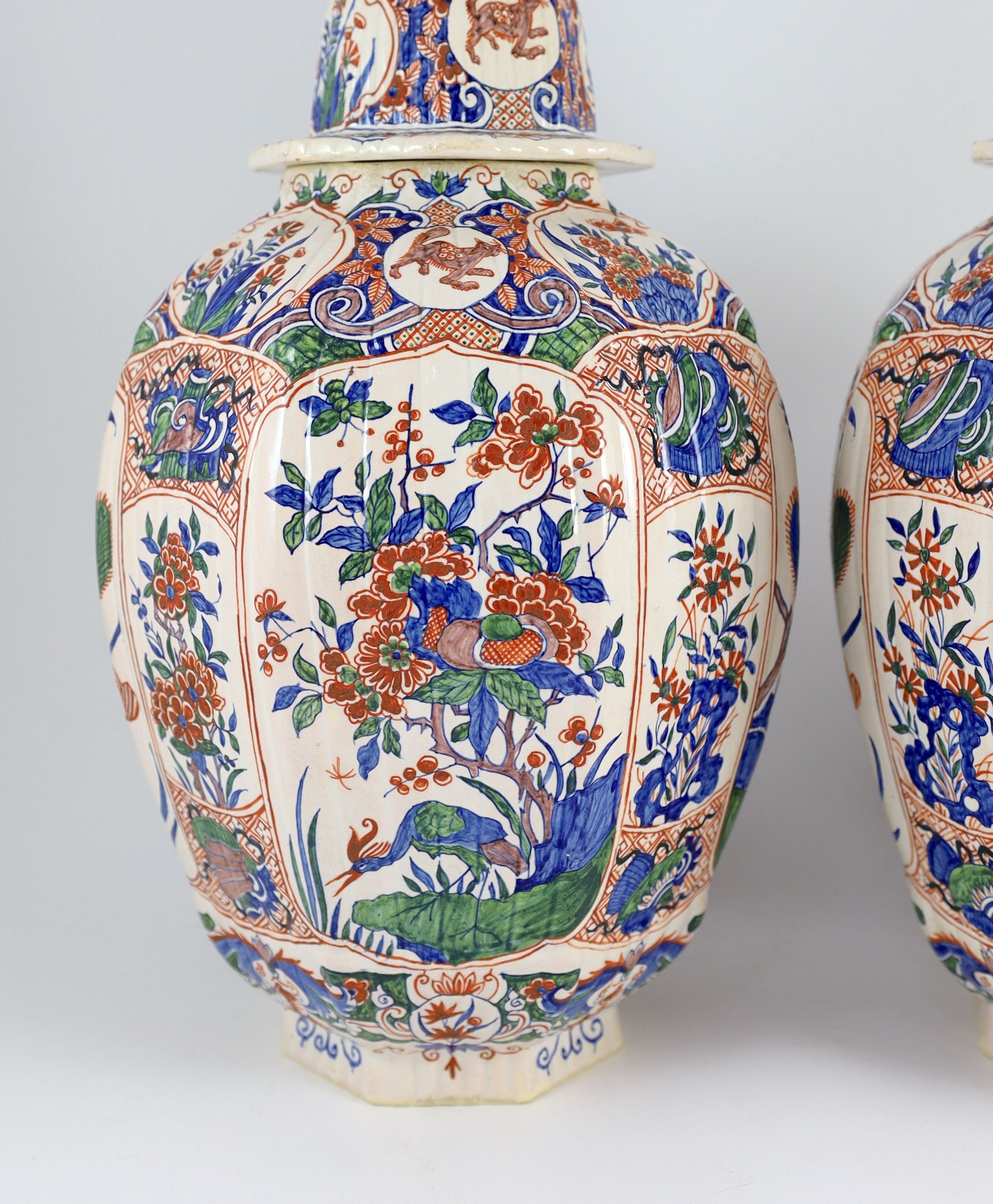 A pair of large Delft jars and covers, Pieter Kocx factory De Grieksche A, c.1701-1722, 50.5cm high, damage to covers